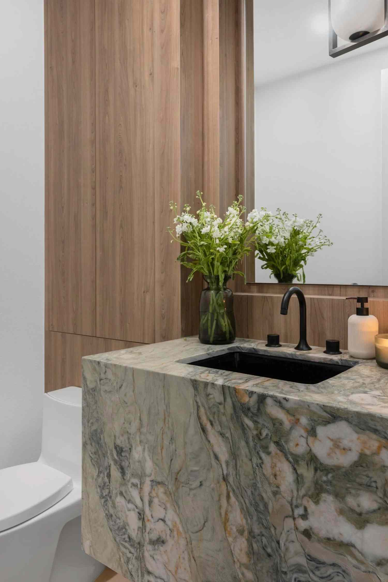 powder bathroom with a green marble sink
