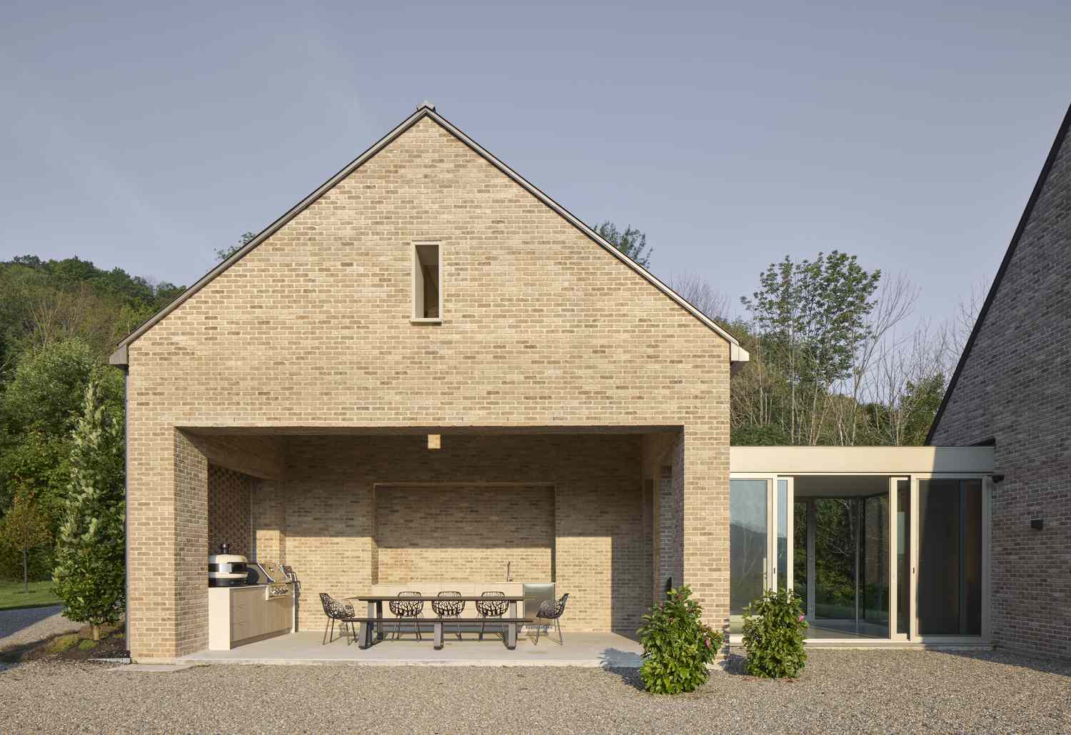 an outdoor patio under a brick pitched roof