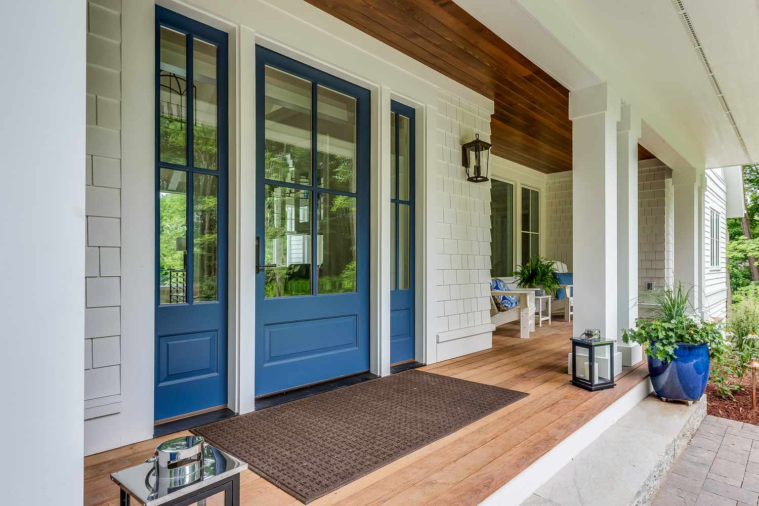 Blue painted front door accented with white siding
