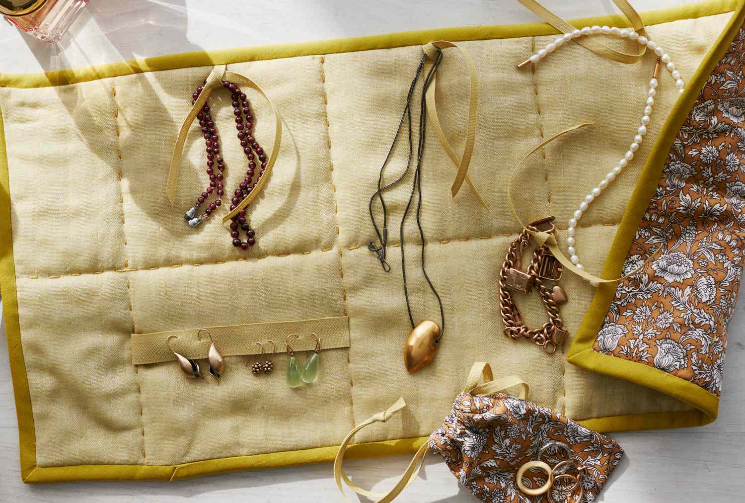 An open jewelry organizer displaying necklaces earrings and bracelets
