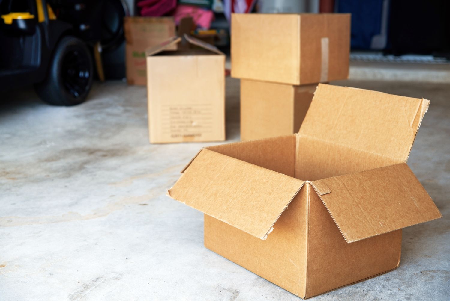 Cardboard boxes placed on a floor some open and some closed