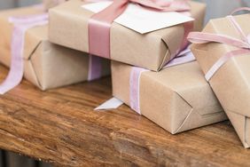 reception gifts in brown wrapping with pink and purple ribbon bows