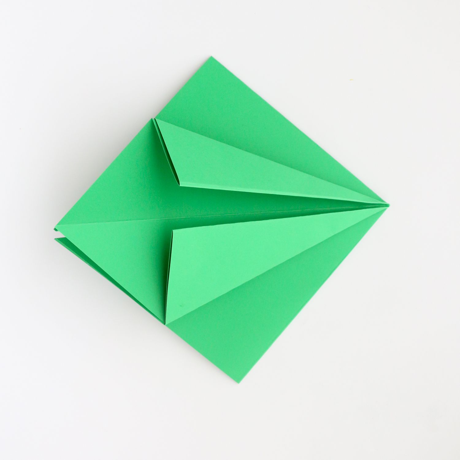 Green piece of paper in a kite shape