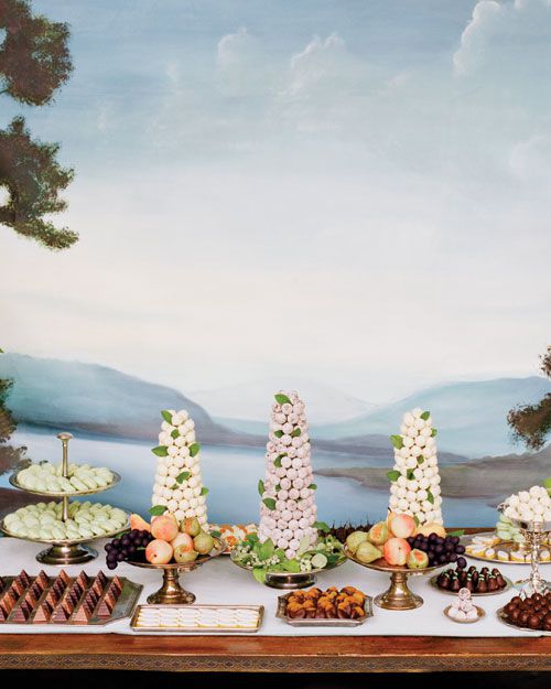 Wedding dessert table with truffles, marzipan fruits, chocolate-dipped apricots, and almond cookies.