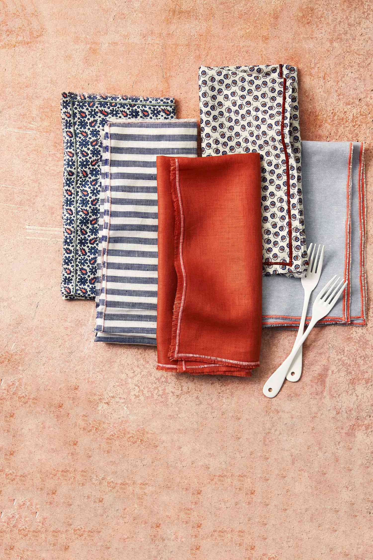 edged cloth napkins orange blue stripes folded