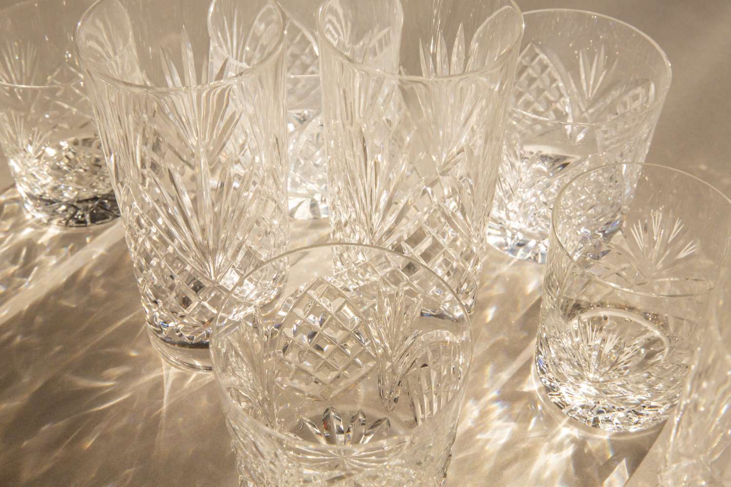 Drinking glasses, crystal glasses, leaded glass antique glassware or barware. Hydration concept of fancy glassware for clean empty glasses for fine dining, water consumption, fragile thrift store antiques, or lead poisoning. Part of a series.