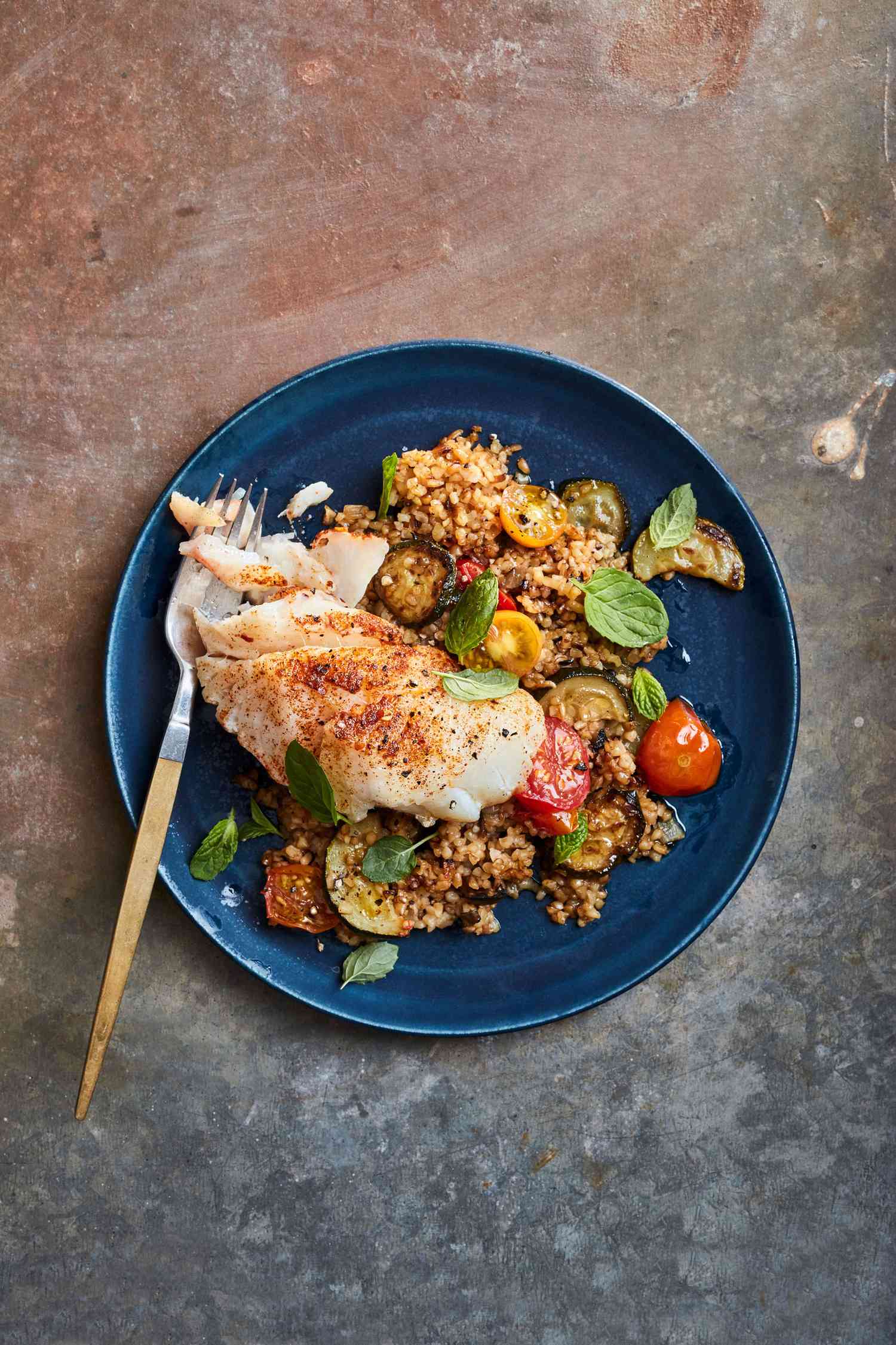 braised cod and bulgur with zucchini and tomatoes