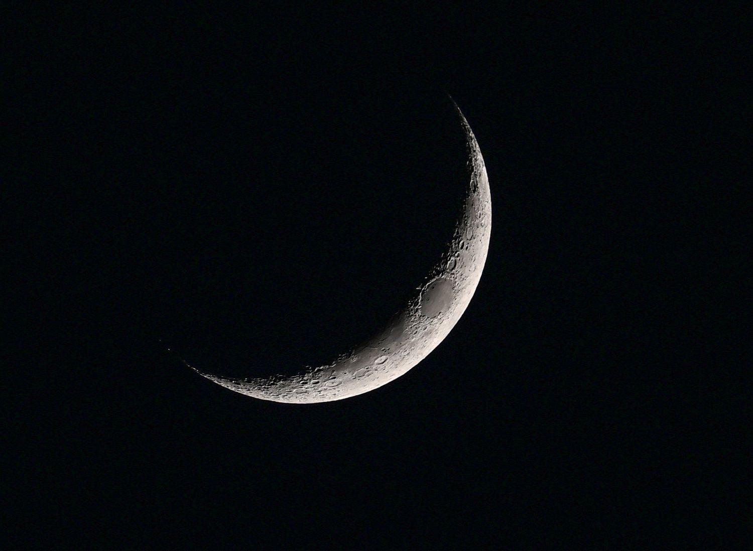 Crescent moon is seen during night time in Ankara, Turkiye on January 14, 2024. 