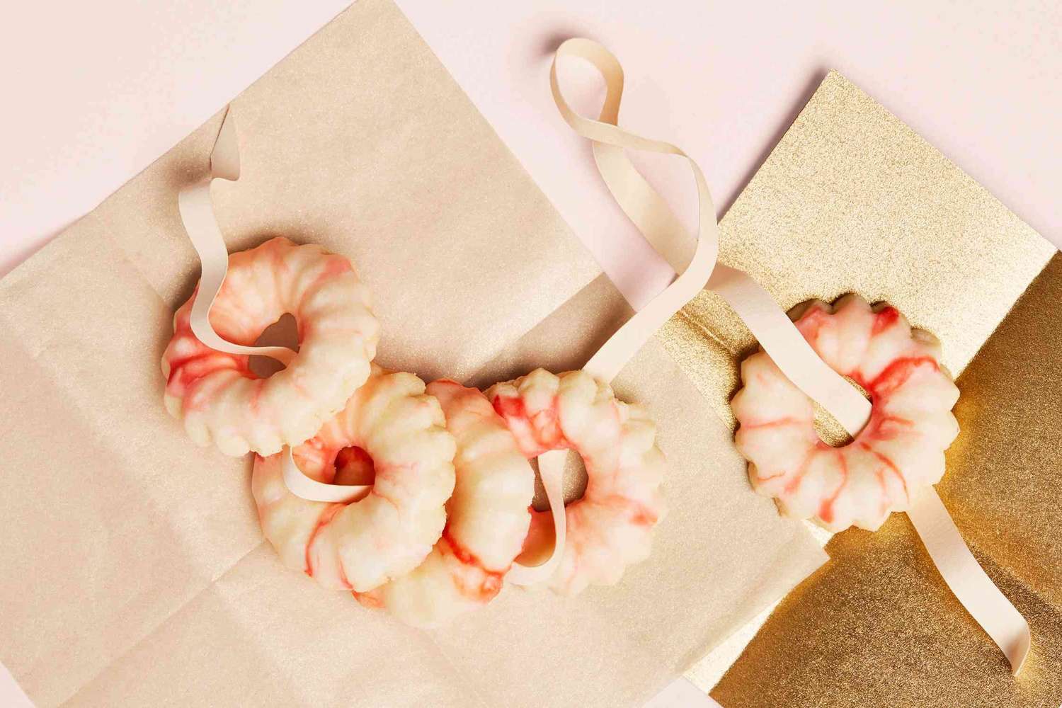 Peppermint spritz cookies arranged on a decorative surface with ribbons