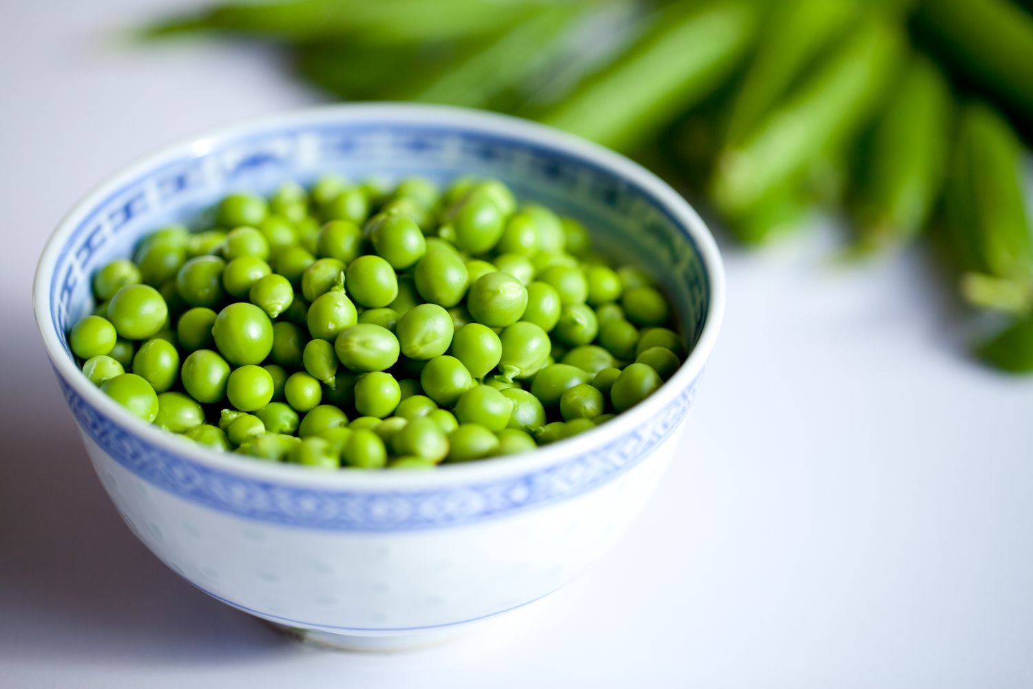 green peas in a blue and white bowl