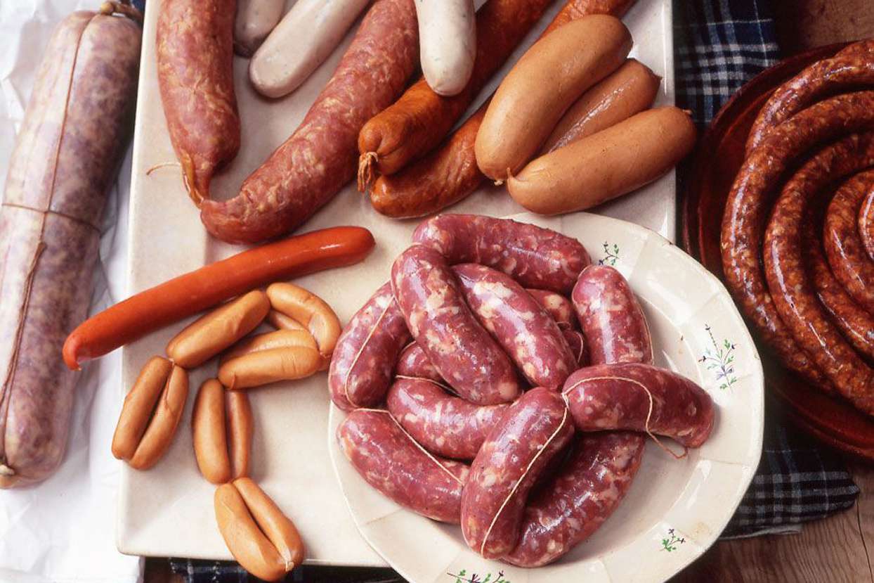 variety of sausages on white platter