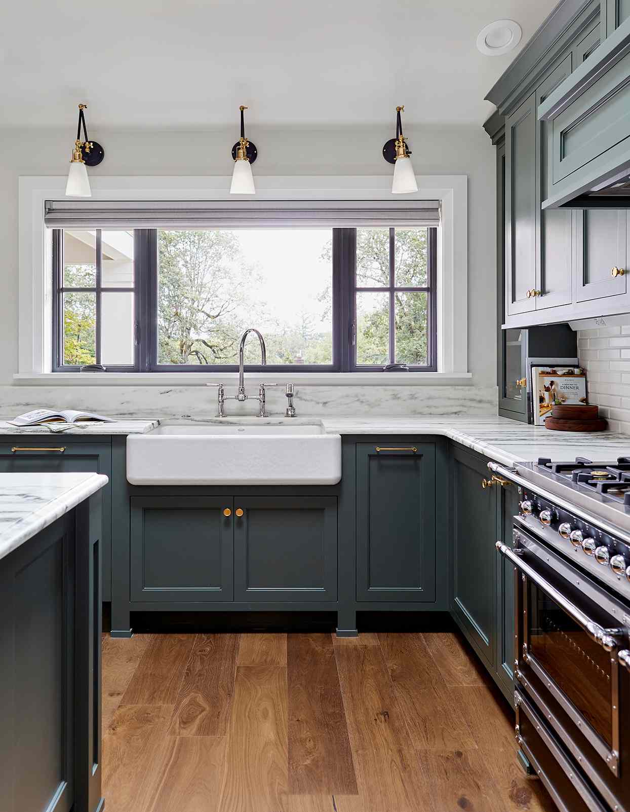 short delicate marble backsplash deep teal cabinets