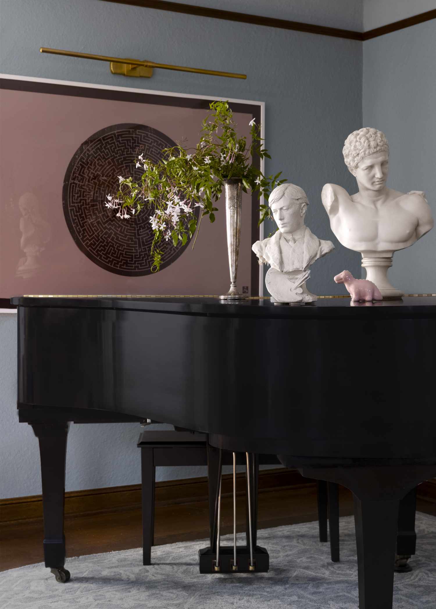 blue room with decorative objects and a piano