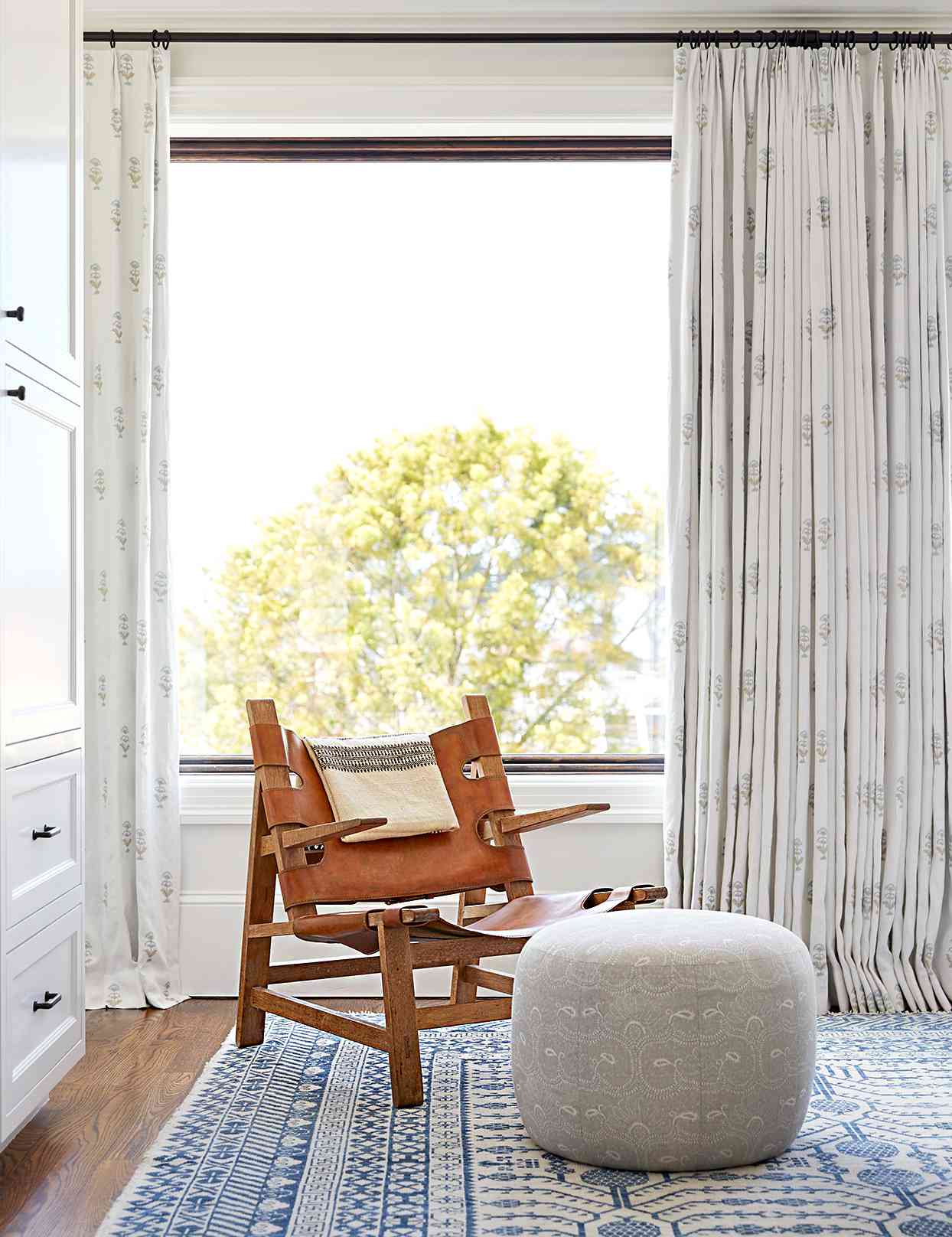 Chair on front of window with ottoman