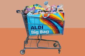 A shopping cart filled with groceries and an Aldibranded reusable bag with colorful stripes