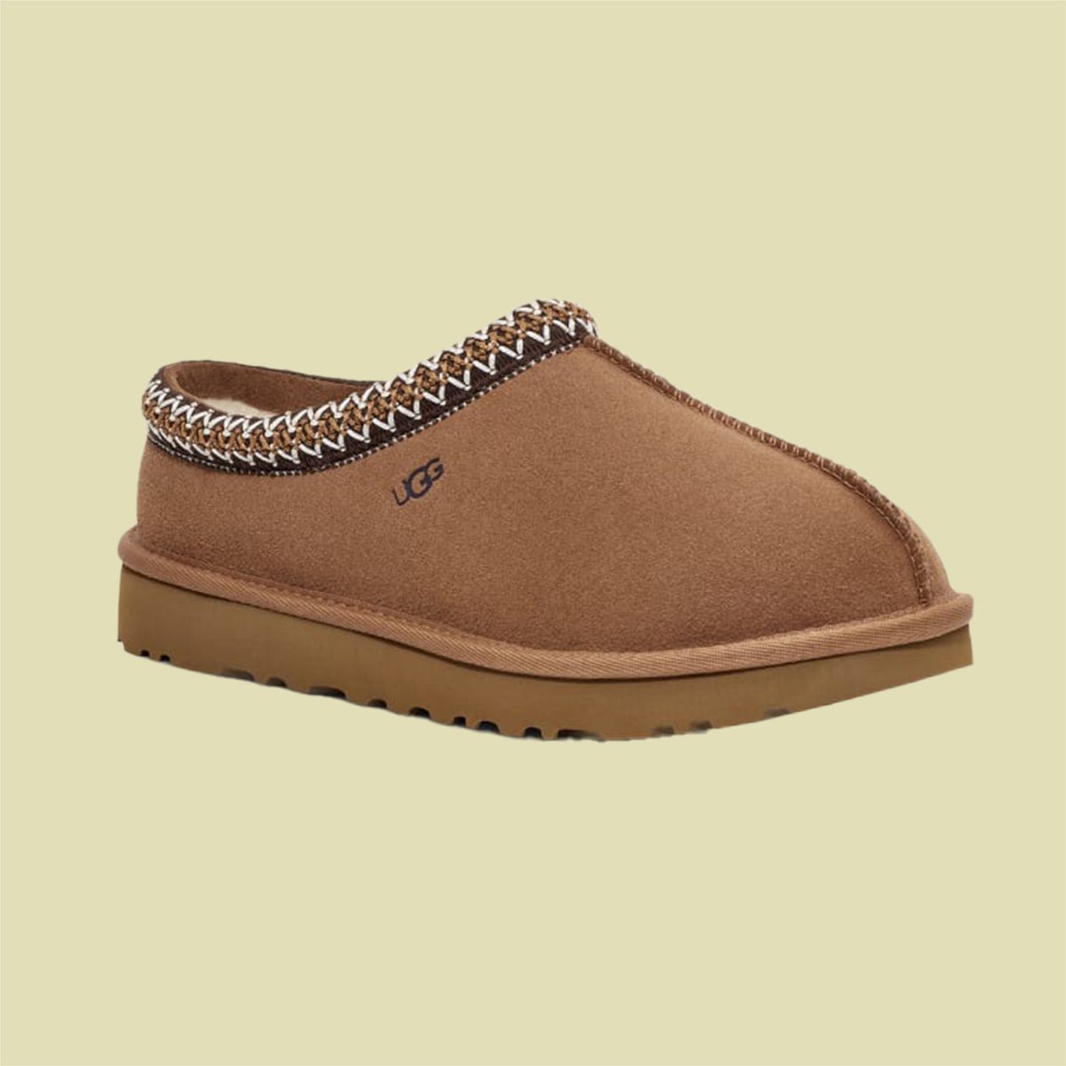 UGG brown slipper on a pale green background