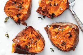 Baked sweet potatoes with thyme and sea salt on a light background