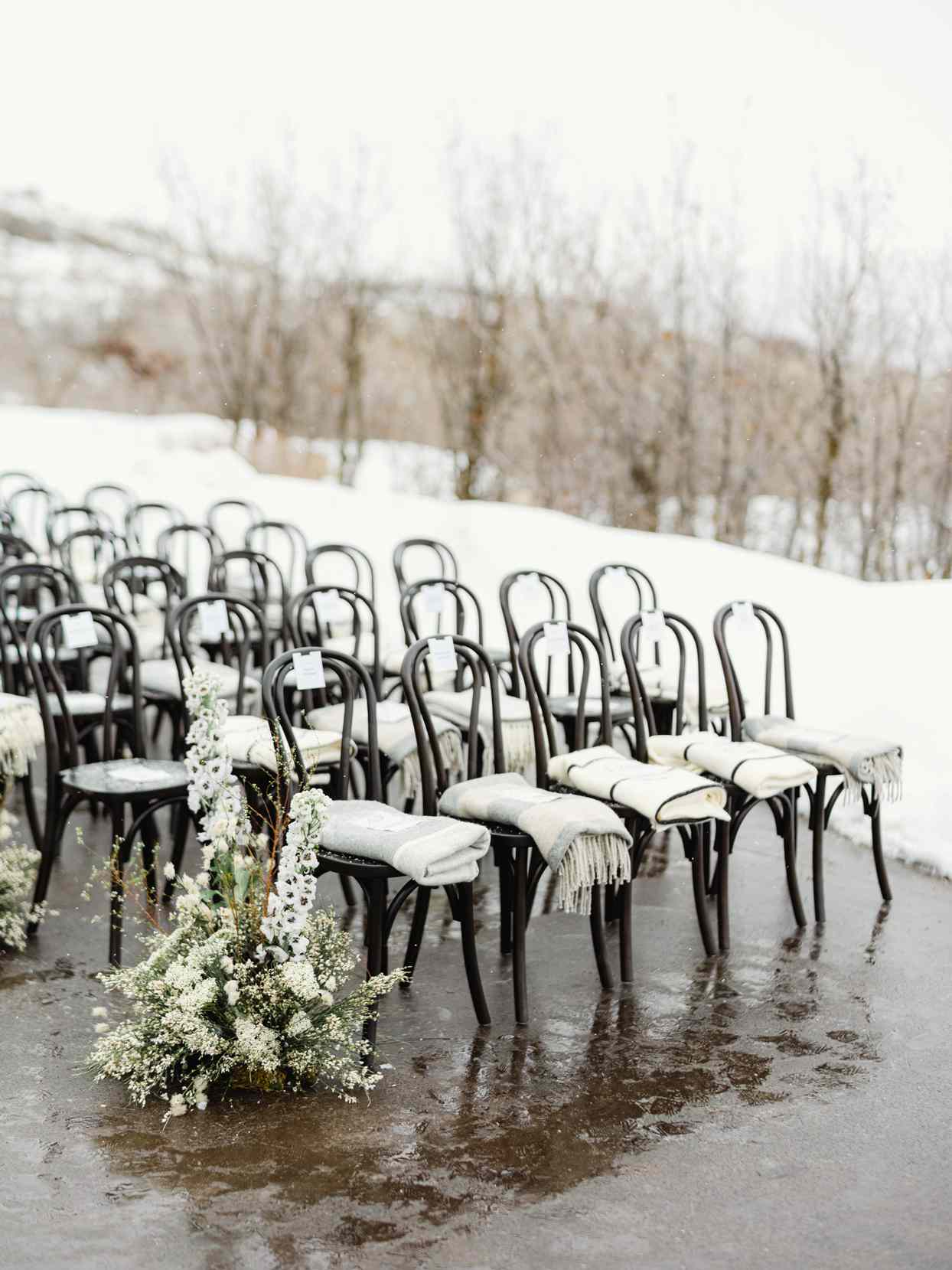 black wedding chairs with individual blankets