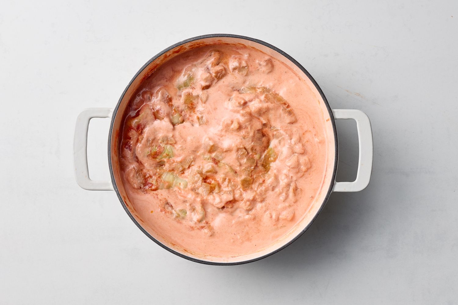 A pot of cooked stuffed cabbage dish in a creamy tomato sauce