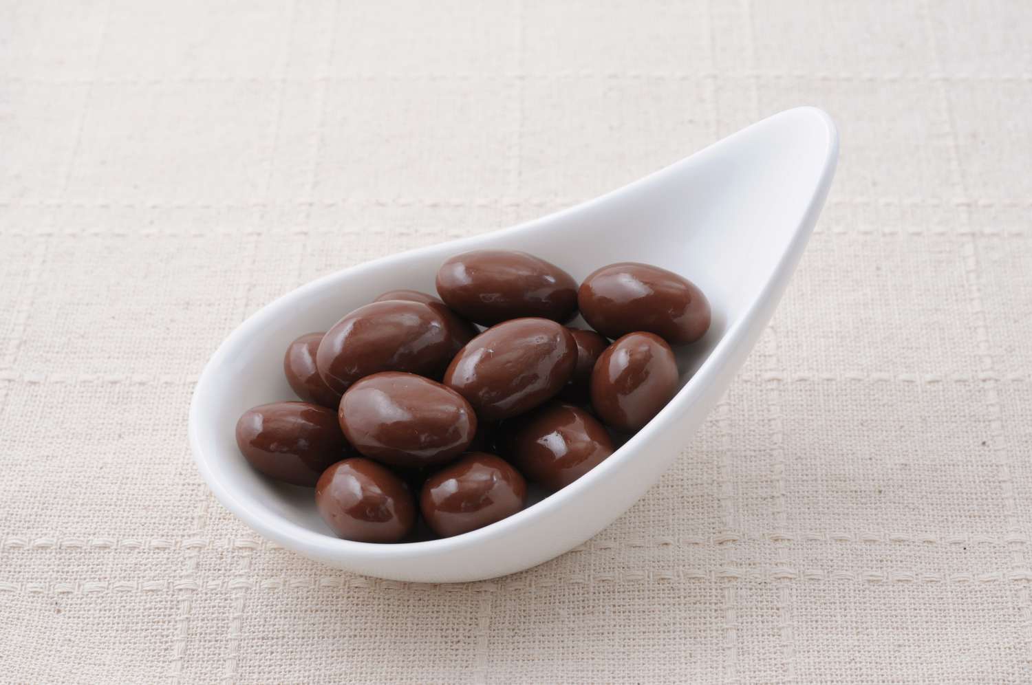 Chocolate-covered almonds in a bowl