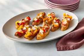 Platter of grilled pepper bruschetta arranged on slices of baguette