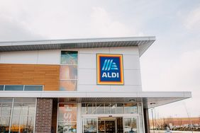 Exterior view of an Aldi supermarket entrance and logo on the building