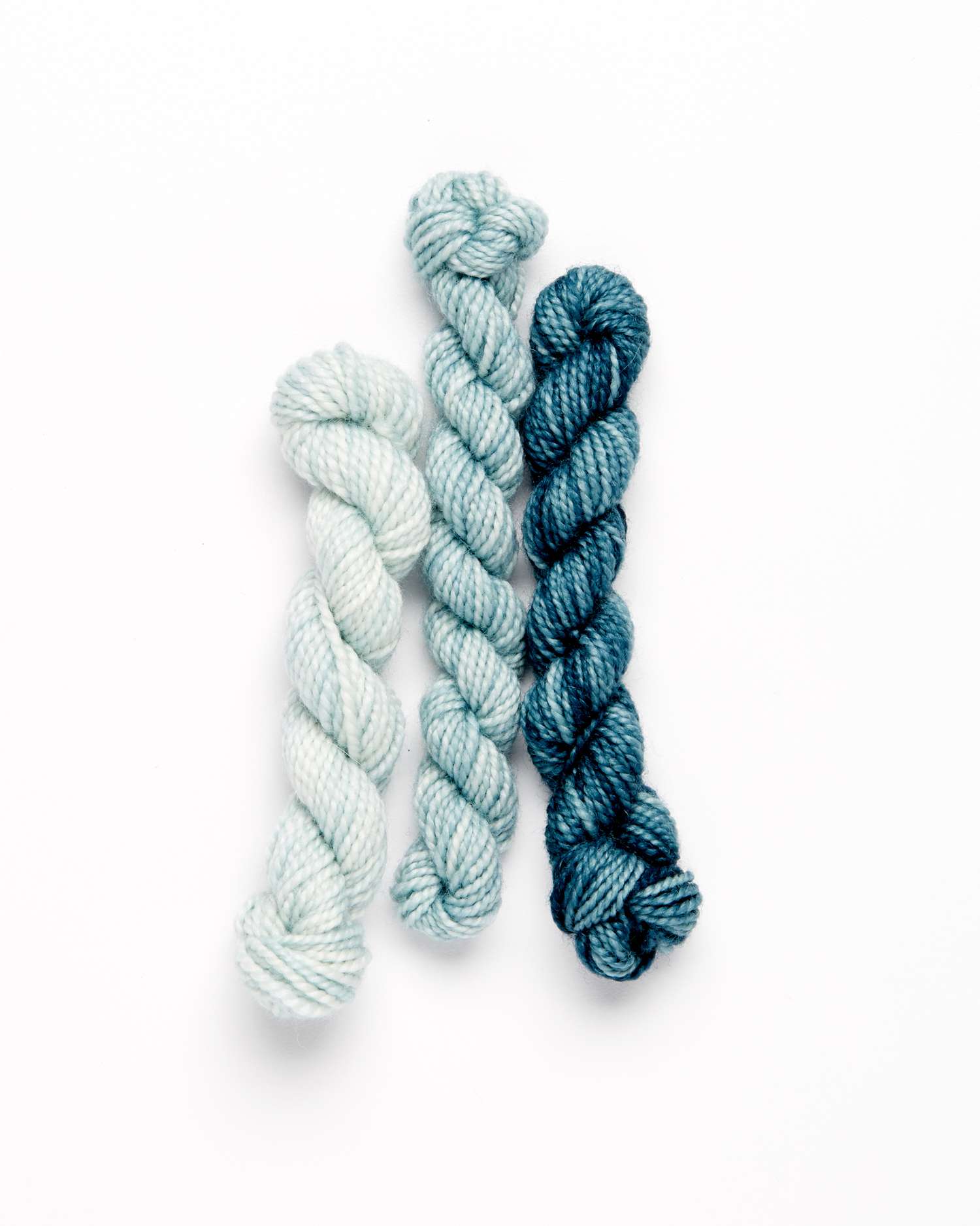 blue embroidery wool yarn against a white background