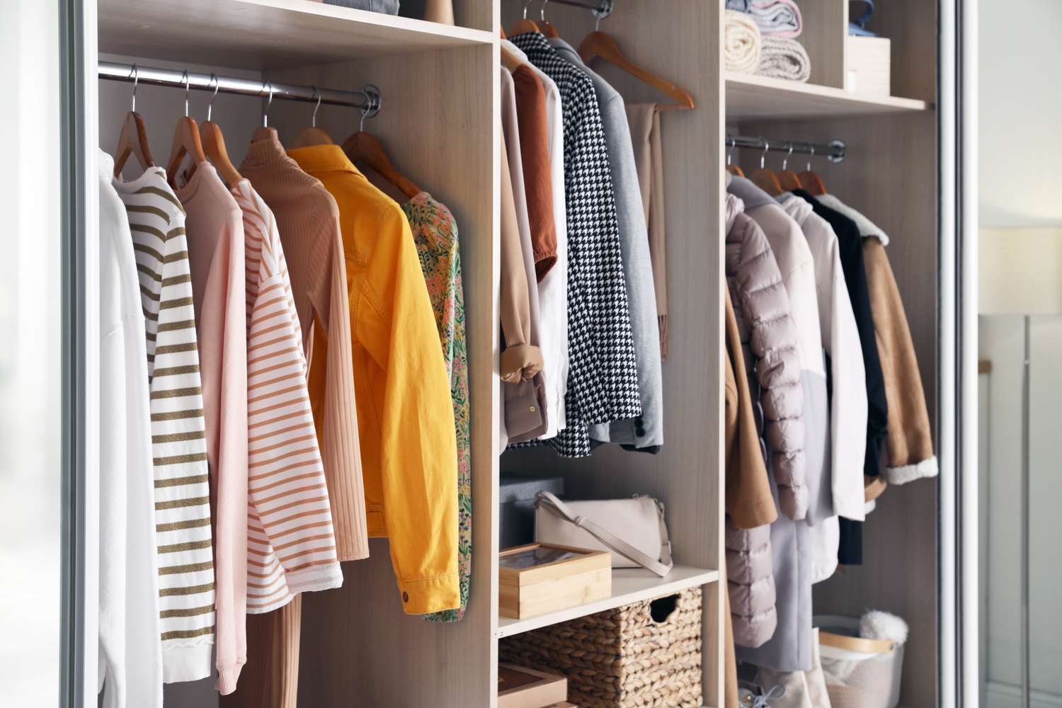 Organized wardrobe with hanging clothes and stored accessories