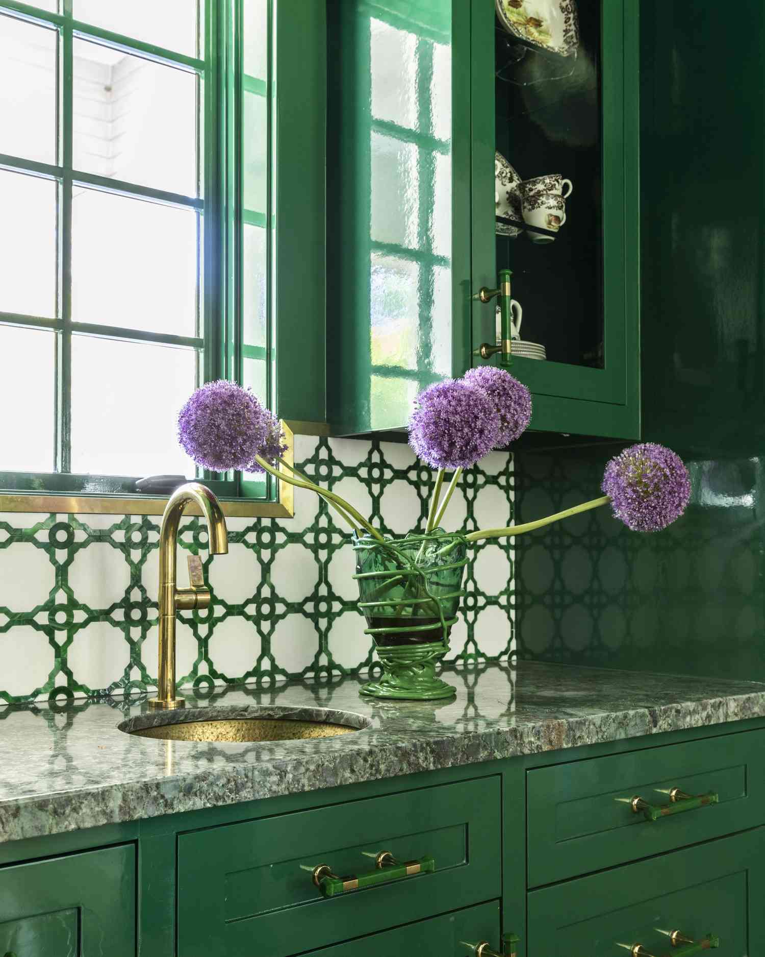 green kitchen with tiled backsplash