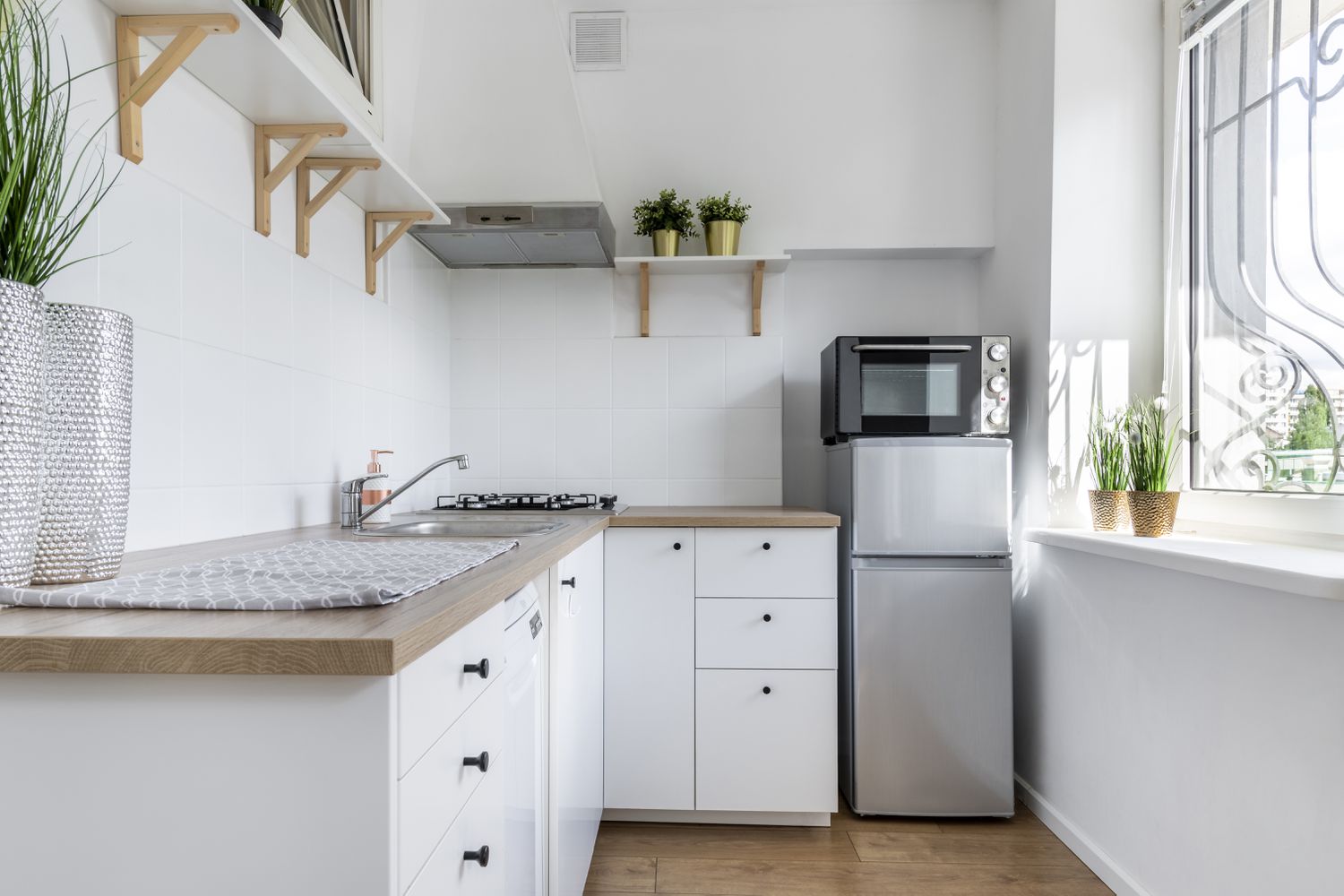 Modern kitchen with microwave on top of fridge