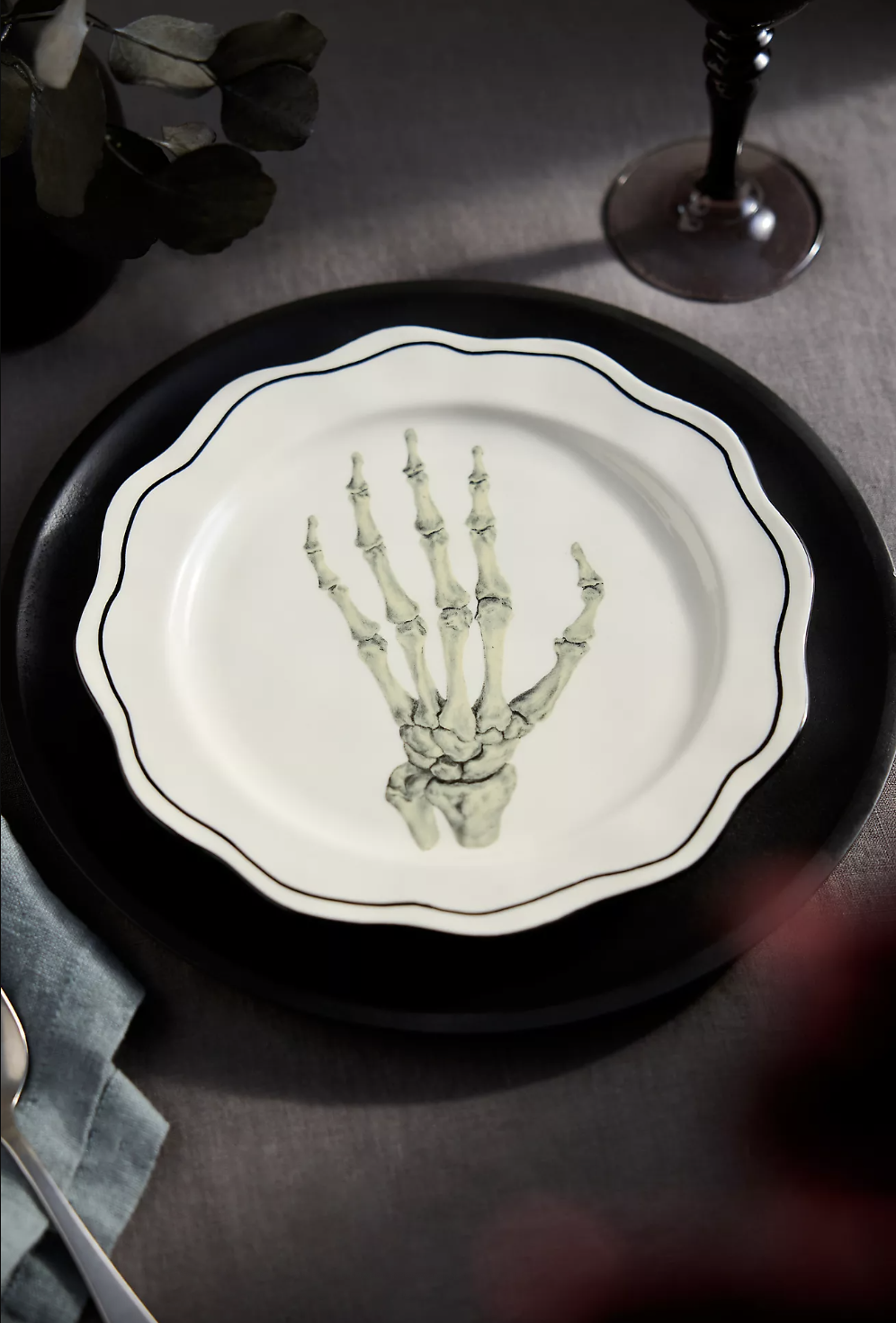 Plate with skeletal hand design on a table setting