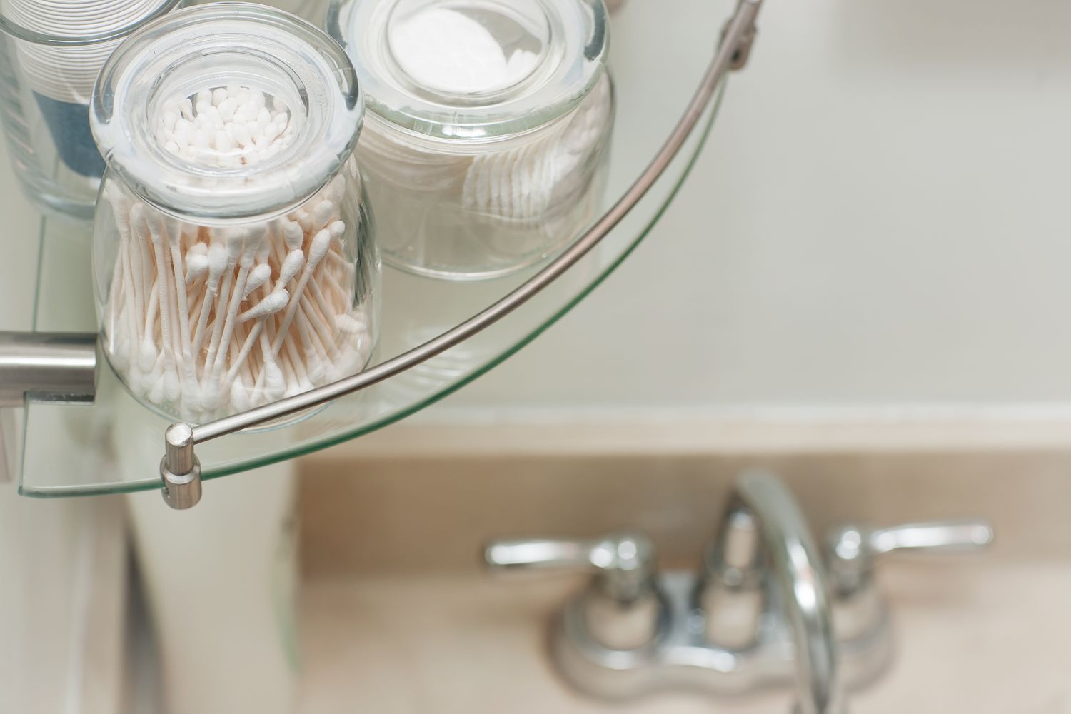 Cotton swabs organized in glass jars in bathroom