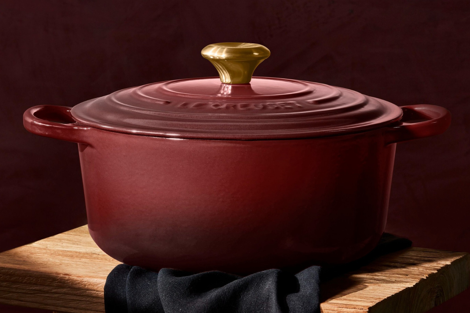 A lidded cooking pot on a wooden surface