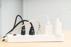 Power strip with multiple cords and adapters plugged in