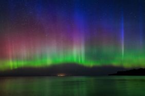 Aurora borealis over a body of water at night