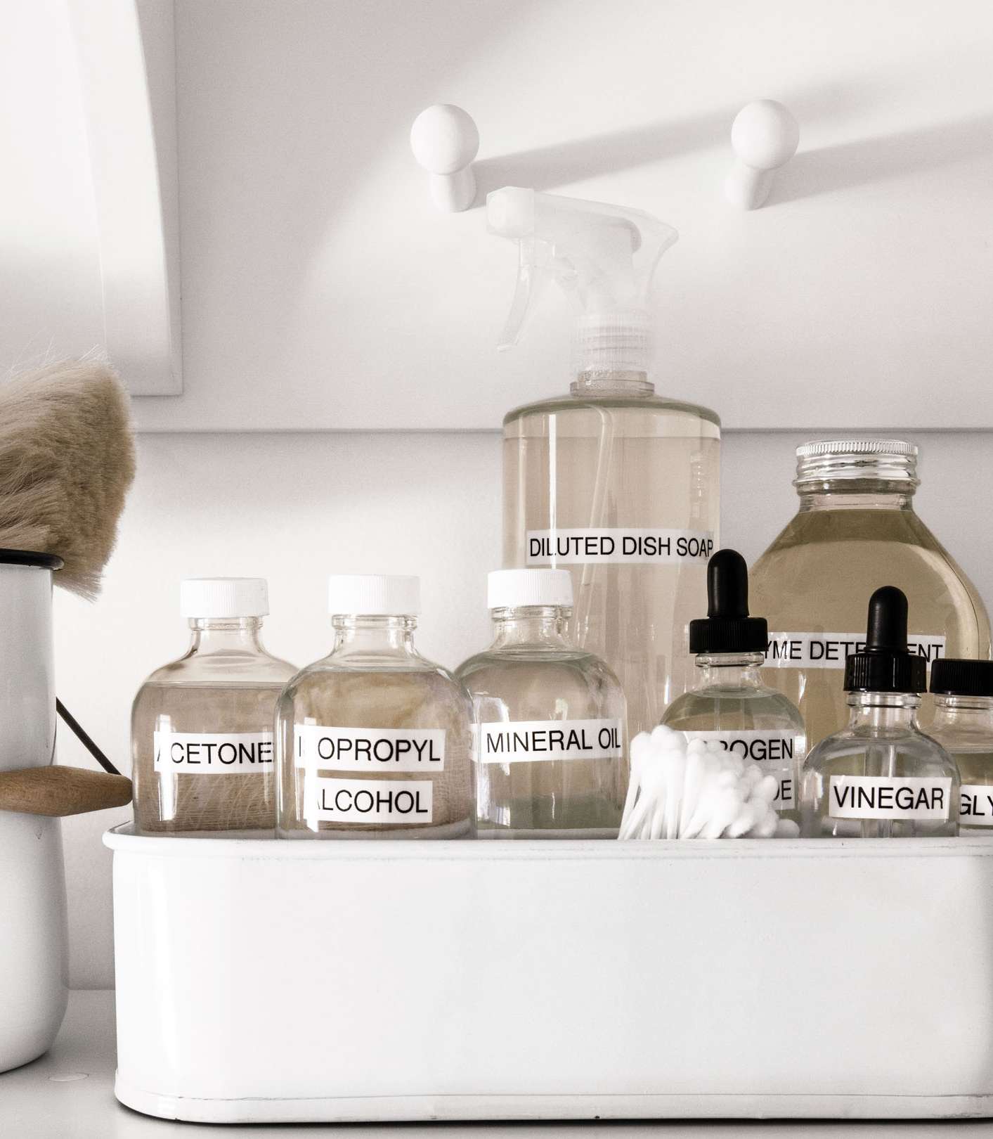 white container filled with labeled bottles for stain removal