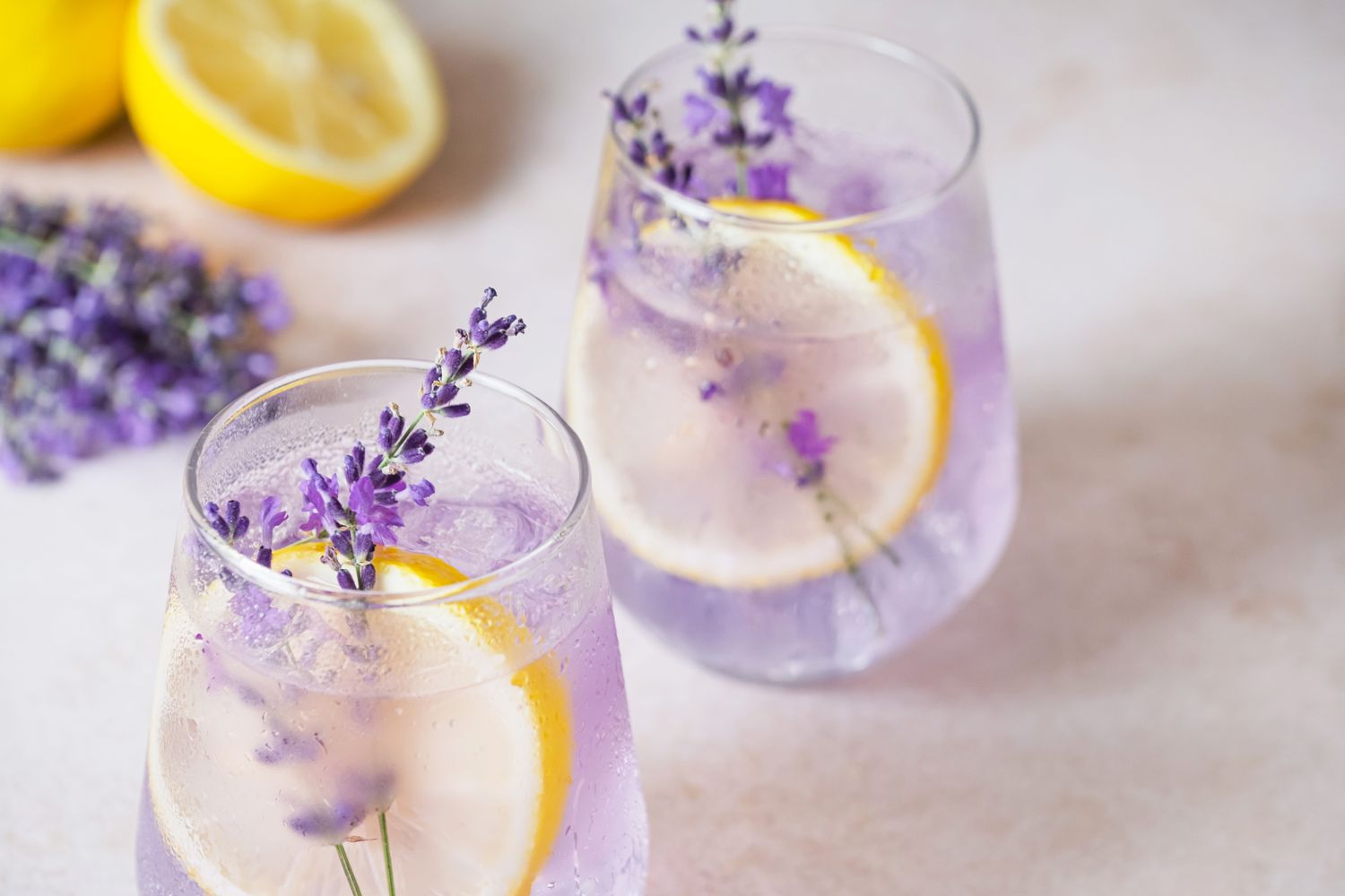 Two glasses of lavenderinfused drink with lemon slices