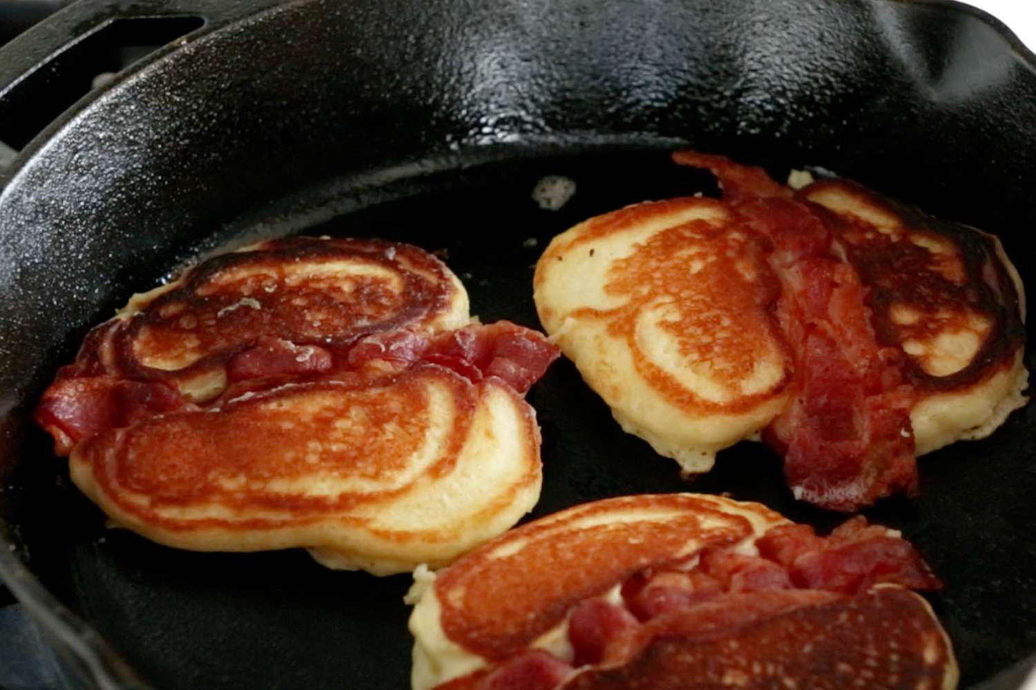 bacon pancakes in cast iron skillet pulled back