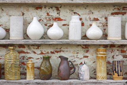 ceramic vintage vases on wooden shelves