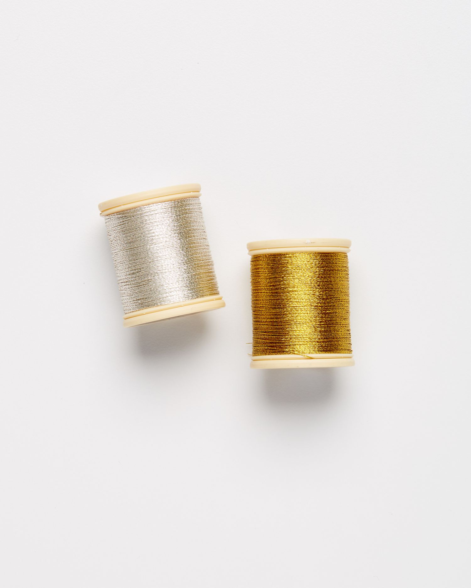 two spools of metallic embroidery thread