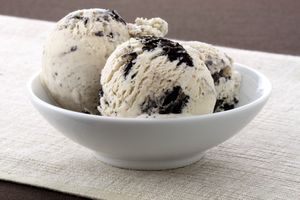 A bowl containing two scoops of cookies and cream ice cream