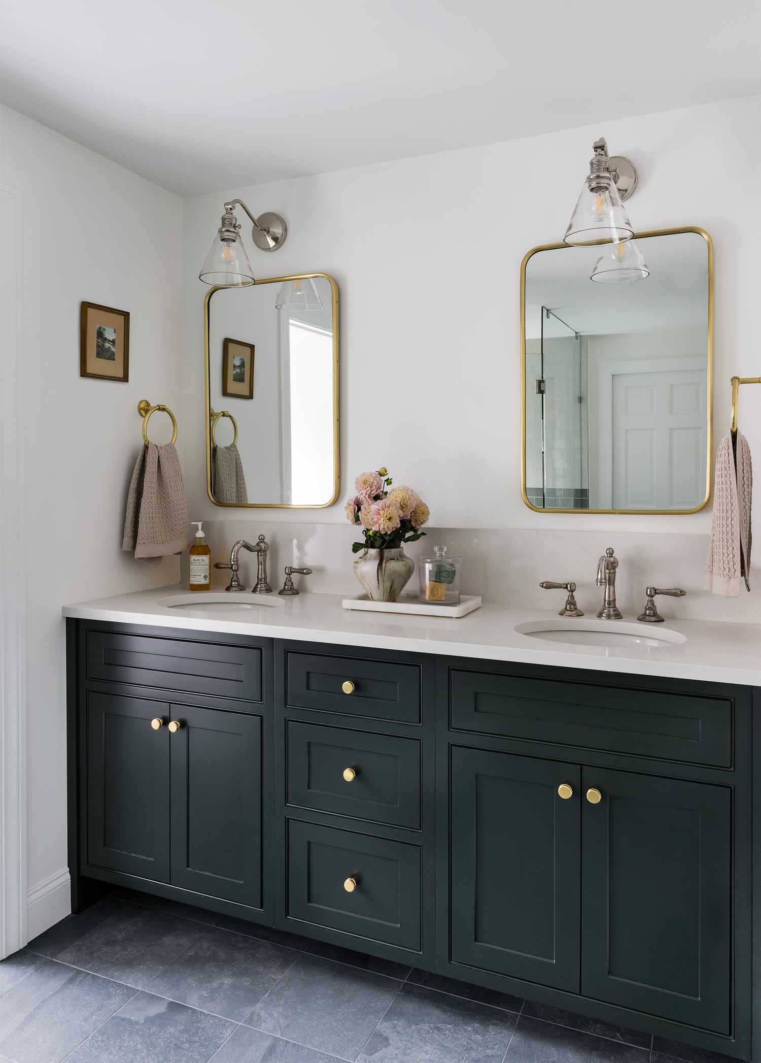 a bathroom with dark green cabinets