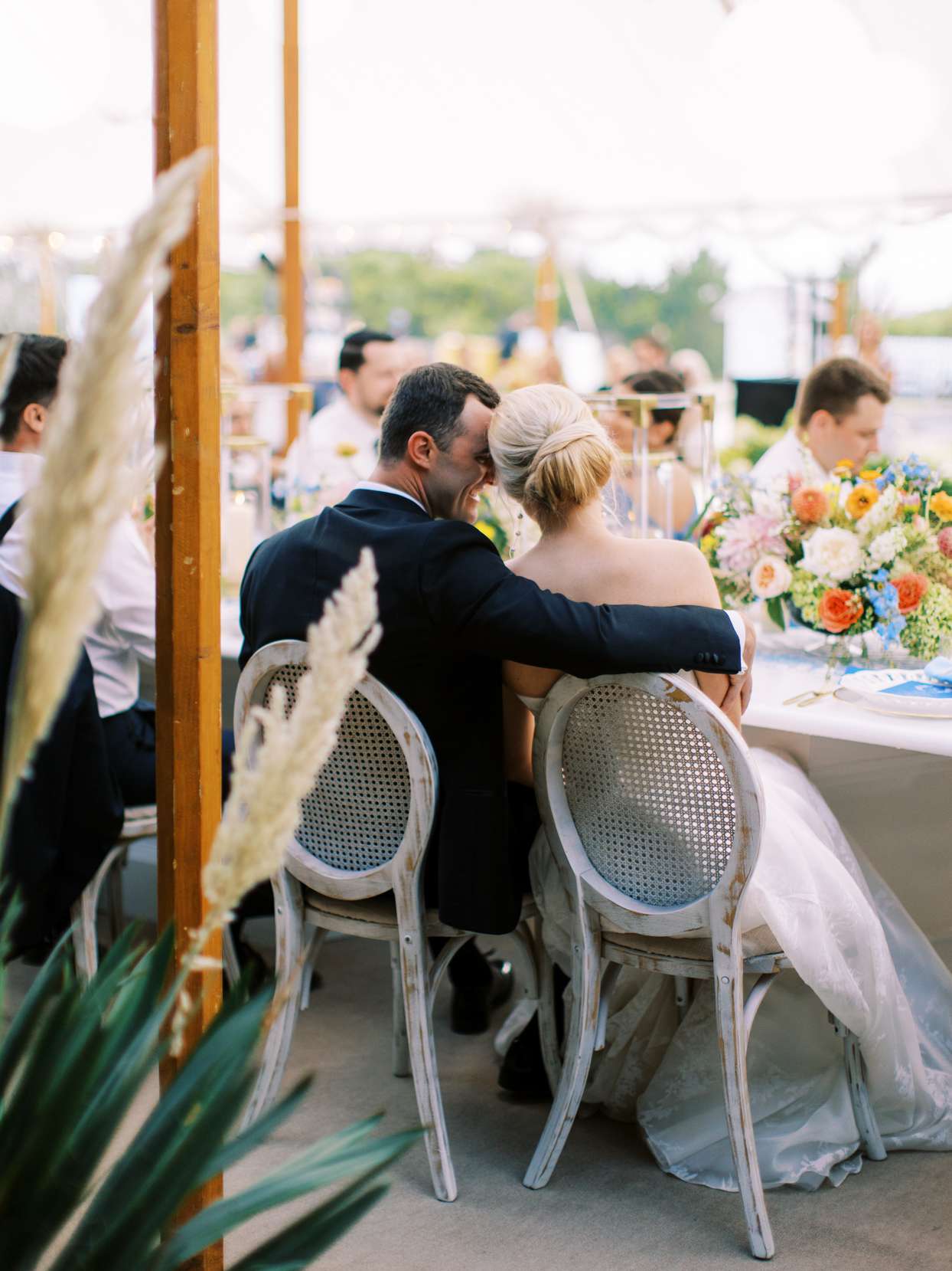 couple embracing at table during wedding reception