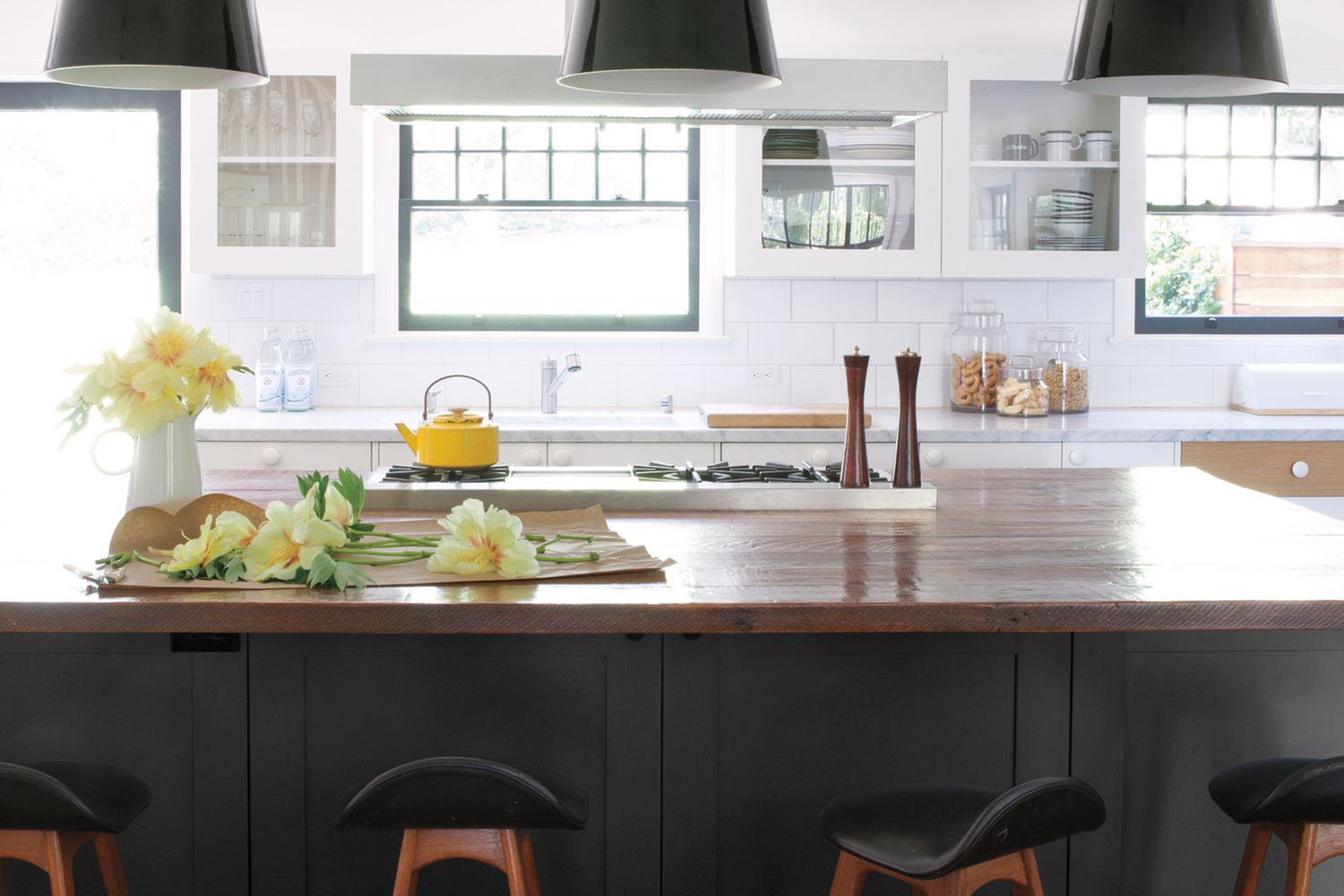 Kitchen with bright colored flowers and tea kettle