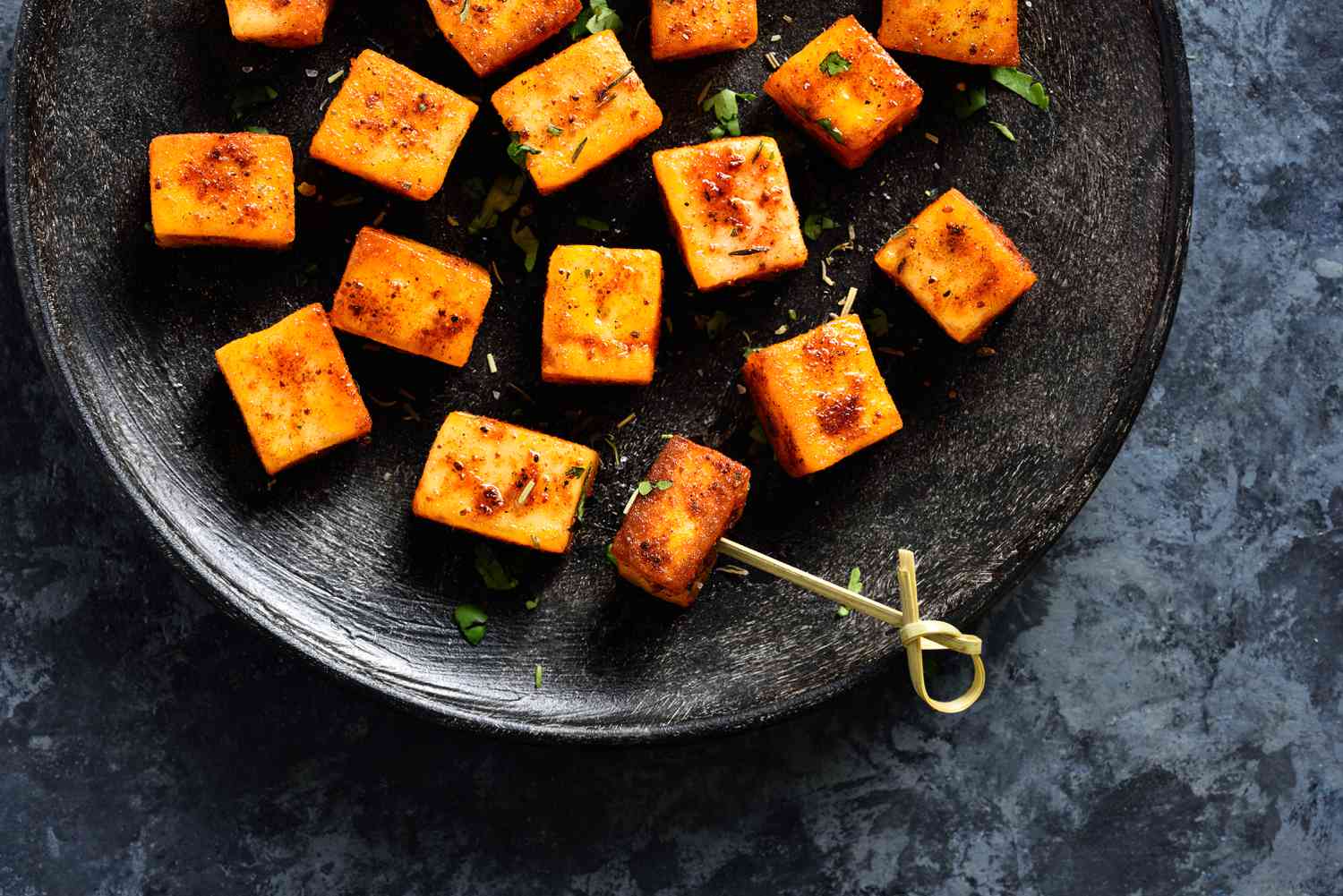 Close up view of pan fried paneer on a plate