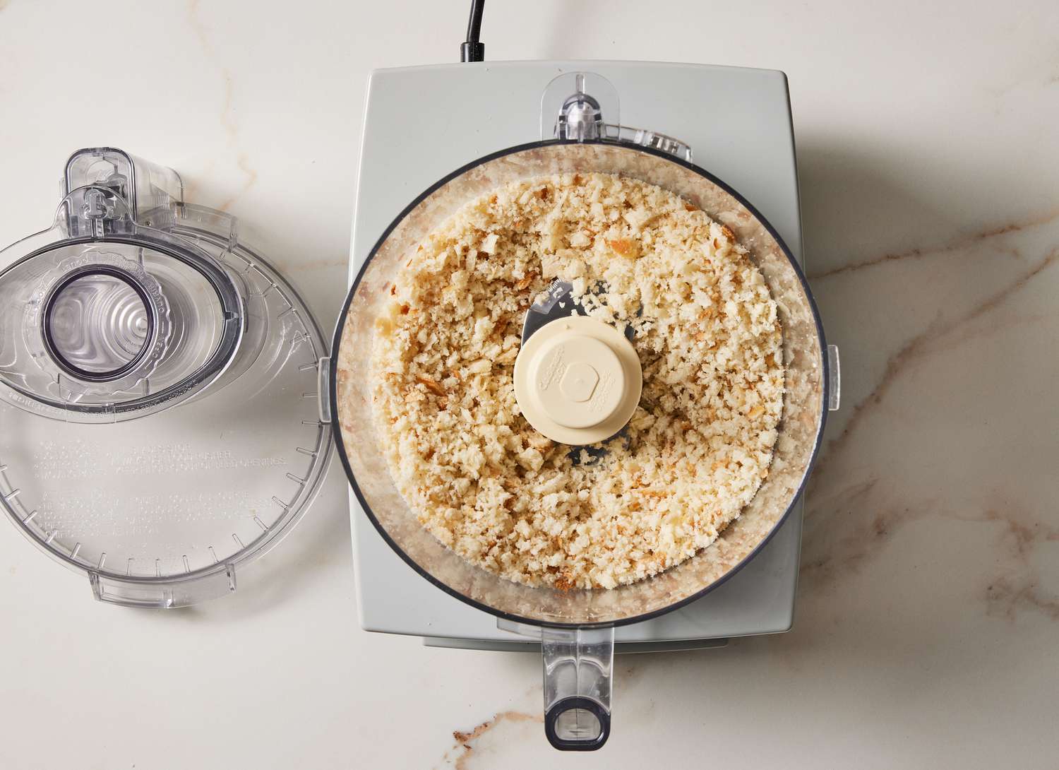 overhead view of a food processor with bread crumbs in it
