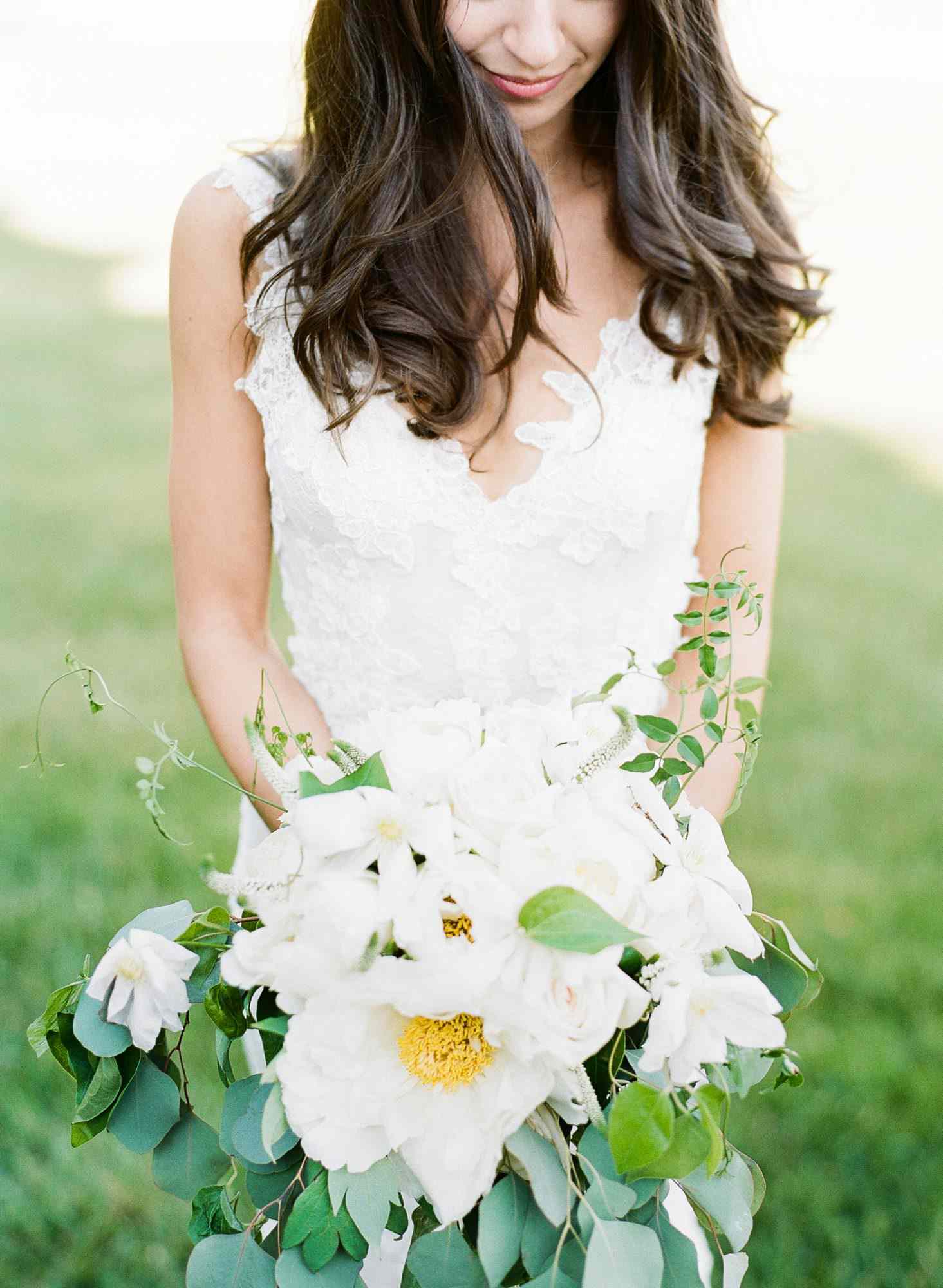 bride holding white bouquet