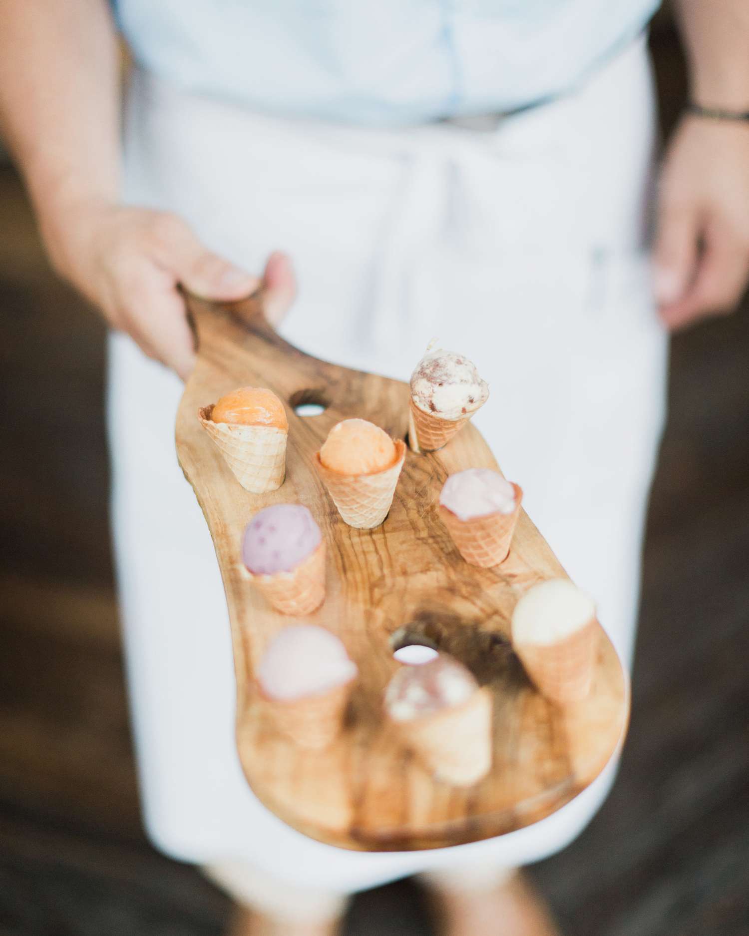 mini ice cream cones served on wooden serving block