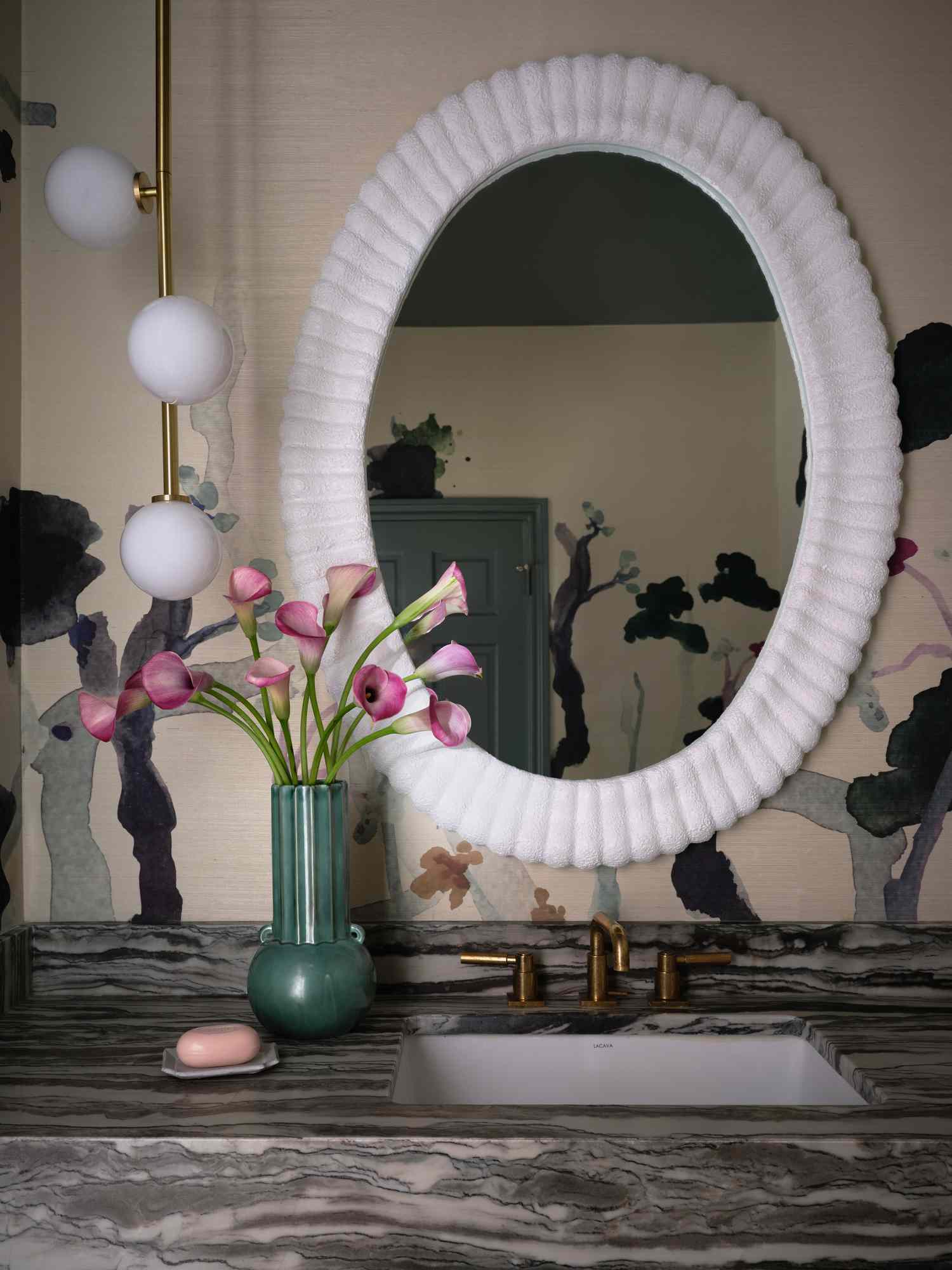 A mirror with a light next to it 