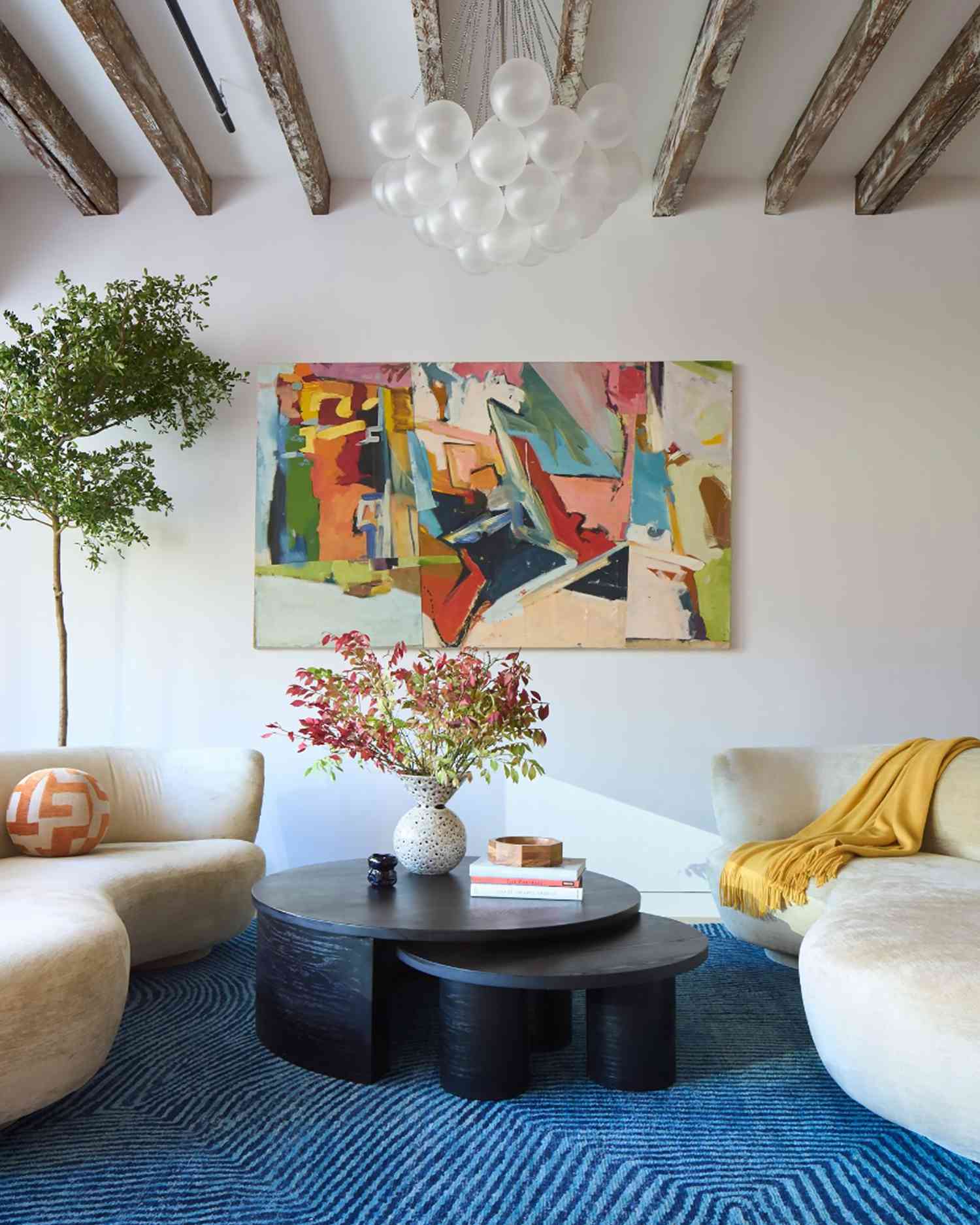 eclectic living room with sofas, blue carpet, a painting